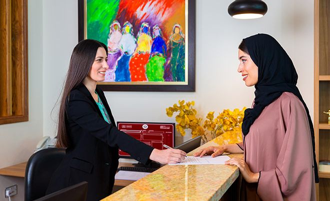 Receptionist helping clients at the front desk