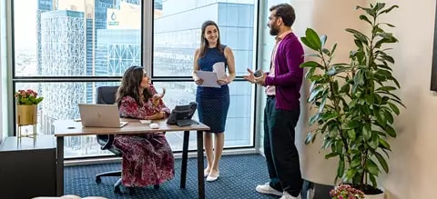 Clients brainstorming in a fully equipped serviced office with a city view at Servcorp’s Commercial Bank Plaza.